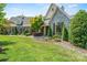 Beautiful stone house featuring manicured front lawn and professional landscaping at 5112 Mill Race Ln, Lancaster, SC 29720