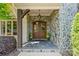 Stone porch features a decorative wood framed double door with iron accents at 5112 Mill Race Ln, Lancaster, SC 29720
