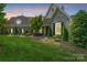 Charming stone facade home with manicured lawn, mature trees, and inviting landscape at 5112 Mill Race Ln, Lancaster, SC 29720