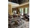 Comfortable living room with sofa, tufted ottoman, and fireplace at 5112 Mill Race Ln, Lancaster, SC 29720