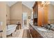Luxurious bathroom features a soaking tub, double vanity with granite counters, and neutral tile at 5112 Mill Race Ln, Lancaster, SC 29720