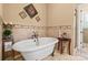 Charming bathroom with a clawfoot tub, vintage-style fixtures, and neutral tones at 5112 Mill Race Ln, Lancaster, SC 29720