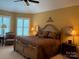 Comfortable main bedroom with ceiling fan, windows, and nightstands with lamps at 5112 Mill Race Ln, Lancaster, SC 29720