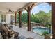 Covered outdoor living space overlooking the pool and lush backyard at 5112 Mill Race Ln, Lancaster, SC 29720