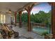 Covered patio with comfortable seating overlooking a sparkling pool and lush backyard at 5112 Mill Race Ln, Lancaster, SC 29720
