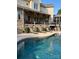 Backyard oasis featuring a sparkling pool, covered patio, and luxurious lounge seating at 5112 Mill Race Ln, Lancaster, SC 29720