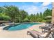 Large swimming pool surrounded by lush greenery and lounge chairs at 5112 Mill Race Ln, Lancaster, SC 29720