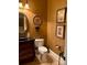 Chic powder room with decorative vanity, round mirror, and unique wall art at 5112 Mill Race Ln, Lancaster, SC 29720