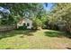 Spacious backyard featuring a privacy fence and access to an outbuilding at 5229 Milford Rd, Charlotte, NC 28210