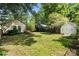 Large backyard with lush green grass and a shed in the background at 5229 Milford Rd, Charlotte, NC 28210