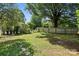 Large backyard surrounded by a wood fence and mature trees at 5229 Milford Rd, Charlotte, NC 28210