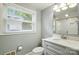 Bathroom featuring updated vanity, mirror, and a glass-enclosed shower at 5229 Milford Rd, Charlotte, NC 28210