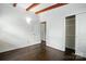 Bedroom featuring hardwood floors, closet, exposed beams, and natural light at 5229 Milford Rd, Charlotte, NC 28210