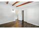 Bright bedroom featuring hardwood floors and exposed beam ceiling at 5229 Milford Rd, Charlotte, NC 28210