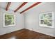 Bedroom featuring hardwood floors, exposed beams, and natural light from large windows at 5229 Milford Rd, Charlotte, NC 28210