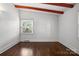 This bright bedroom features hardwood floors, neutral walls, and natural light from large windows at 5229 Milford Rd, Charlotte, NC 28210