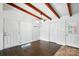 Bright dining room boasts hardwood floors, exposed beam ceiling, and modern light fixture at 5229 Milford Rd, Charlotte, NC 28210
