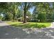 Traditional style house with lush front lawn and mature trees on a sunny day at 5229 Milford Rd, Charlotte, NC 28210
