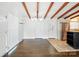 Open living area with wood floors, beams, and access to kitchen and dining areas at 5229 Milford Rd, Charlotte, NC 28210