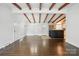 Open living area with wood flooring, exposed beams, and access to the kitchen at 5229 Milford Rd, Charlotte, NC 28210