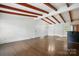 Bright living room with wood floors, beams, and multiple access doors at 5229 Milford Rd, Charlotte, NC 28210