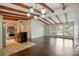 Open concept living space with wood floors, beams, and a kitchen island at 5229 Milford Rd, Charlotte, NC 28210
