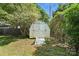 Backyard shed with double doors surrounded by lush greenery at 5229 Milford Rd, Charlotte, NC 28210