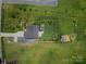 An aerial view showcases a well-maintained yard, fencing, and outdoor storage at 556 Big Lick Rd, Stanfield, NC 28163