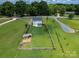 This aerial view showcases the house, the spacious backyard, and some trees at 556 Big Lick Rd, Stanfield, NC 28163