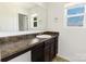 Bathroom featuring a spacious vanity with lots of counter space and a large mirror at 556 Big Lick Rd, Stanfield, NC 28163