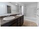 Bright bathroom features a double sink vanity, shower and tub combination with tile flooring at 556 Big Lick Rd, Stanfield, NC 28163