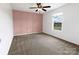 The bedroom features a paneled wall, a ceiling fan, a window with blinds, and carpet at 556 Big Lick Rd, Stanfield, NC 28163
