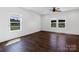 Bright, empty bedroom featuring hardwood floors and multiple windows for plenty of natural light at 556 Big Lick Rd, Stanfield, NC 28163