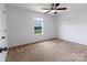 This bedroom features a ceiling fan, a window with blinds, and carpet at 556 Big Lick Rd, Stanfield, NC 28163