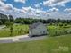 Aerial view of a home with a long driveway, garage, and fenced backyard at 556 Big Lick Rd, Stanfield, NC 28163