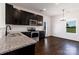 Modern kitchen featuring stainless steel appliances, granite countertops, and dark wood cabinets at 556 Big Lick Rd, Stanfield, NC 28163