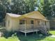 Single-story home with covered porch and wood railings, offering a serene outdoor space at 5881 Robinhood Rd, Fort Lawn, SC 29714