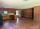 The combined living and kitchen area features warm wood paneling, floors and stainless steel appliances at 5881 Robinhood Rd, Fort Lawn, SC 29714