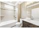 Bright bathroom with a tub, tile surround, vanity with ample storage, and modern fixtures at 6107 Gold Springs Way, Denver, NC 28037