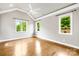 Empty bedroom features natural light with hardwood floors and a vaulted ceiling at 6107 Gold Springs Way, Denver, NC 28037