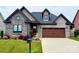 Charming home featuring a stone facade, lush landscaping, and a two-car garage at 6107 Gold Springs Way, Denver, NC 28037