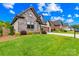 Well-maintained home featuring a stone facade, landscaped yard, and a two-car garage at 6107 Gold Springs Way, Denver, NC 28037