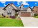 Charming home featuring a stone facade, lush landscaping, and a two-car garage at 6107 Gold Springs Way, Denver, NC 28037