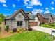 Beautiful home with stone and brick, manicured lawn, and a spacious two-car garage at 6107 Gold Springs Way, Denver, NC 28037