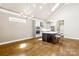 Bright open kitchen with white cabinets, stainless appliances, and island with bar seating at 6107 Gold Springs Way, Denver, NC 28037