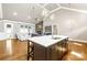 Open concept kitchen with island seating, flowing into a living room with a fireplace at 6107 Gold Springs Way, Denver, NC 28037