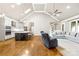 Open-concept living room featuring a modern kitchen, vaulted ceiling, and hardwood floors throughout the space at 6107 Gold Springs Way, Denver, NC 28037