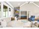 Cozy living room with a stone fireplace, large windows, and plush seating for a relaxing atmosphere at 6107 Gold Springs Way, Denver, NC 28037
