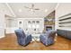 Spacious living room with hardwood floors, stone fireplace, built-in shelving, and comfortable seating arrangement at 6107 Gold Springs Way, Denver, NC 28037