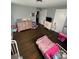 This bedroom features hardwood floors, neutral gray paint, and two closets, complemented by pink decor at 621 N Craige St # 25 & 27, Salisbury, NC 28144
